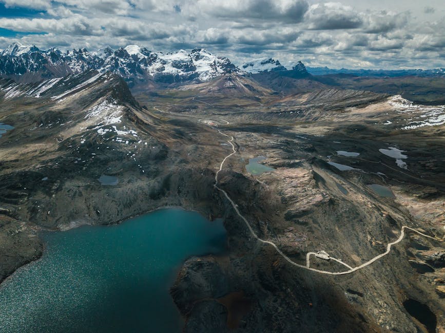 A stunning landscape photograph of the Andes mountains, showcasing the majestic peaks, lush valleys, and diverse ecosystems that inspired Frederic Edwin Church's 'Heart of the Andes' painting.