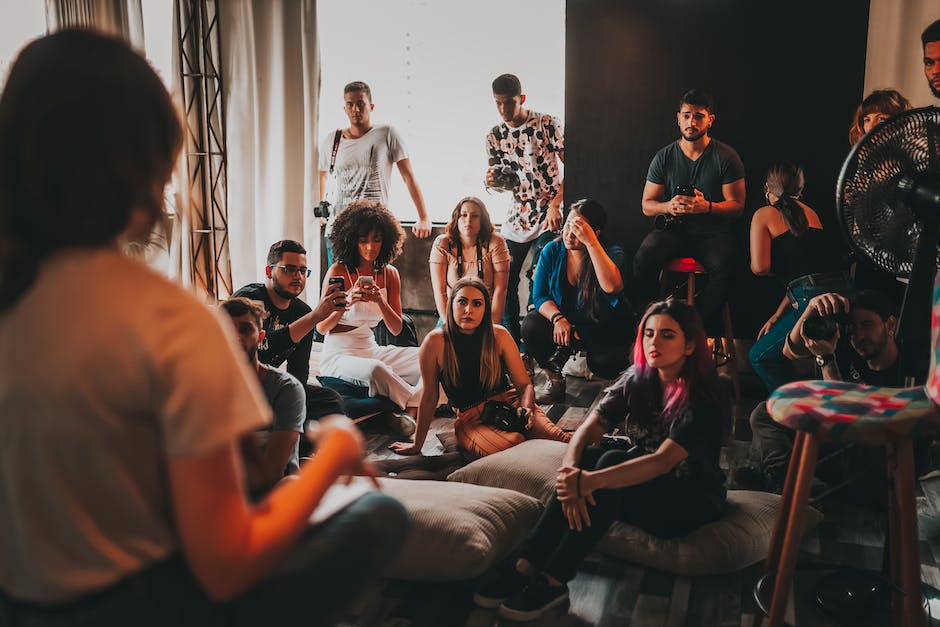 Image depicting a diverse group of people at an art auction, highlighting the importance of diversity and inclusion in the art market