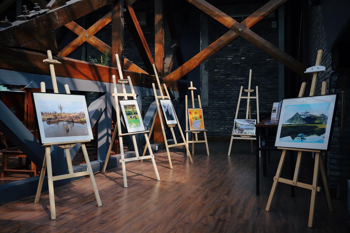 An image of an art auction illustrating the excitement and frenzy of bidding, with participants raising their paddles.