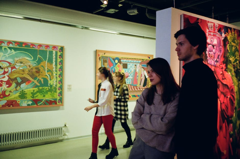 Image depicting two individuals in cloaks standing in a mysterious art gallery.