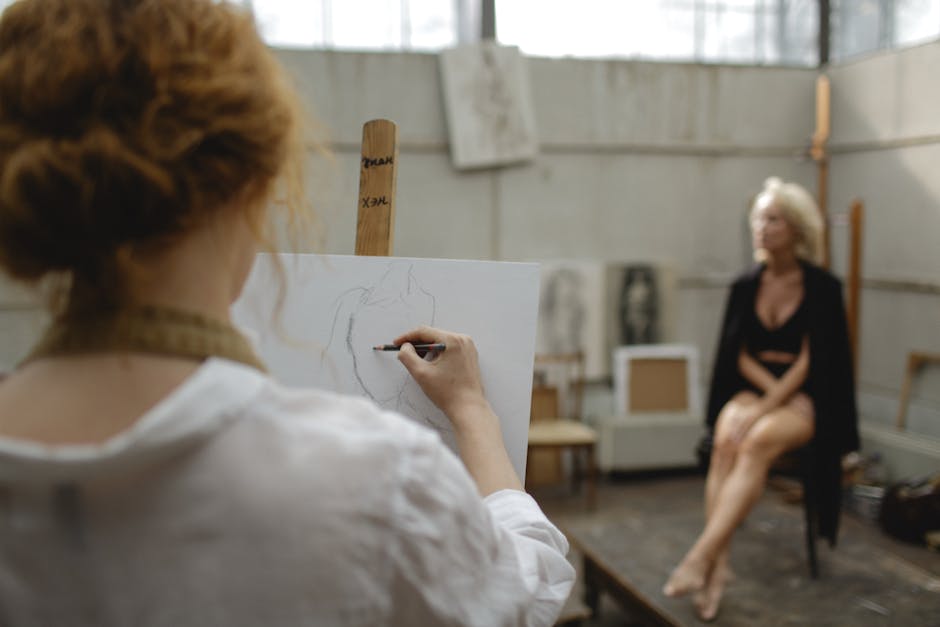 A person deeply absorbed in painting, demonstrating the 'flow' state associated with artistic engagement