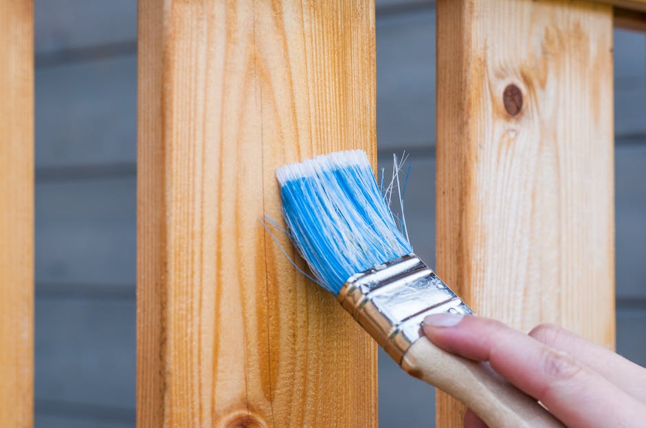 A person holding a paintbrush, ready to create, representing the quest for a mentor in the artistic world.