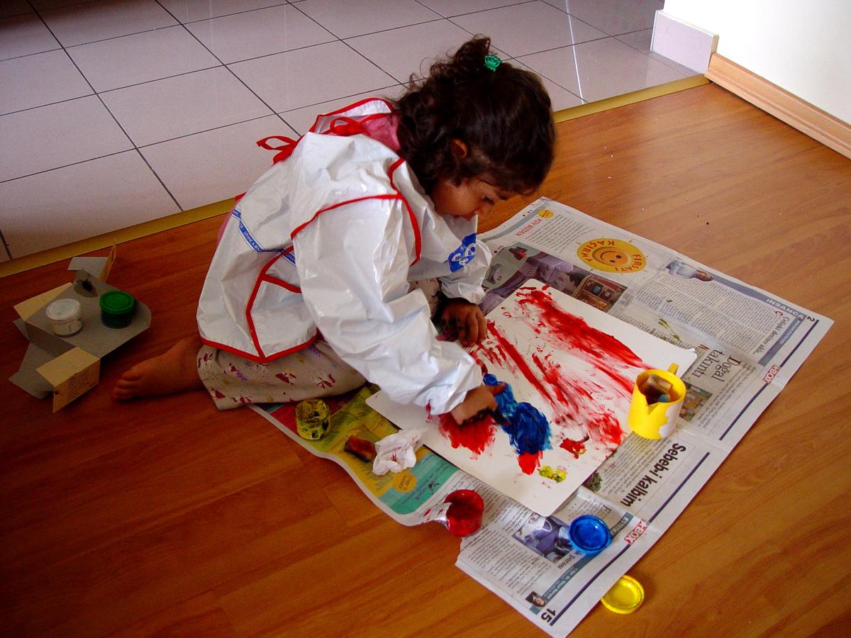 A person expressing emotions through painting during an art therapy session