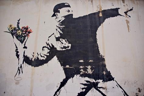 A faded Banksy artwork, illustrating the paradoxical impact of its ephemeral nature on public interaction and market value