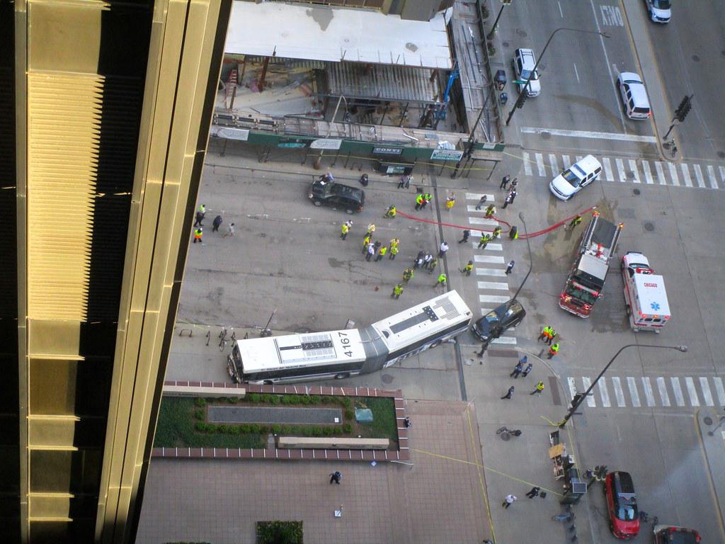 A somber scene depicting the aftermath of a bus accident, with a damaged bus and streetcar