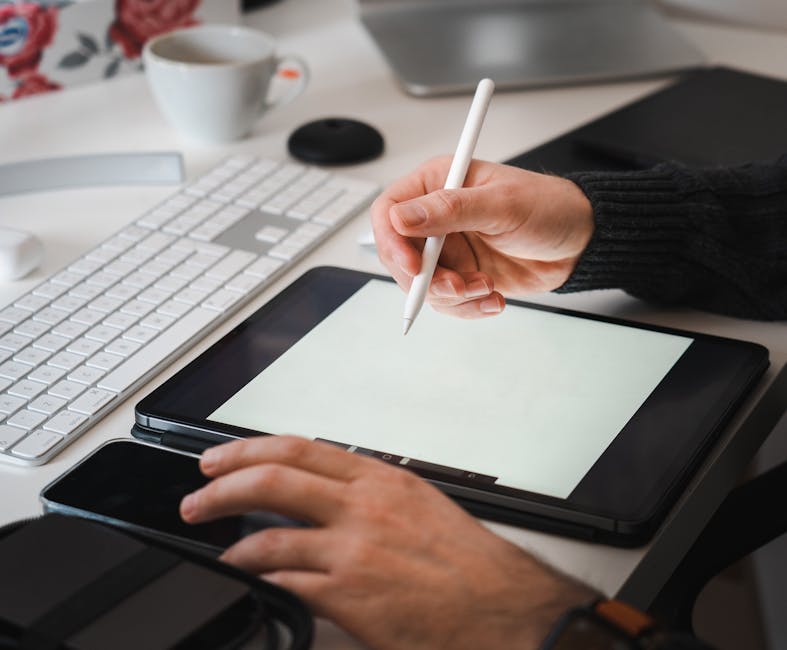 An array of digital art tools including tablets, styluses, and screens displaying various digital art software interfaces