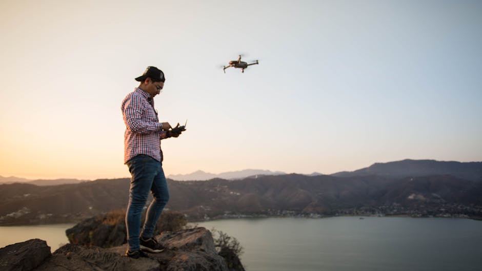 A person being photographed by a drone in a stunning natural landscape, showcasing technological advancements in photography