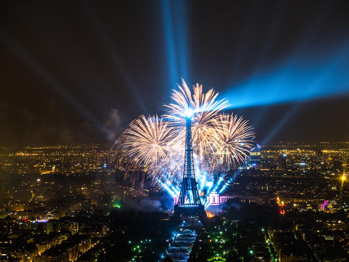 The Eiffel Tower illuminated at night, with its grand lighting display reminiscent of the radiant elements in Van Gogh's 'The Starry Night'