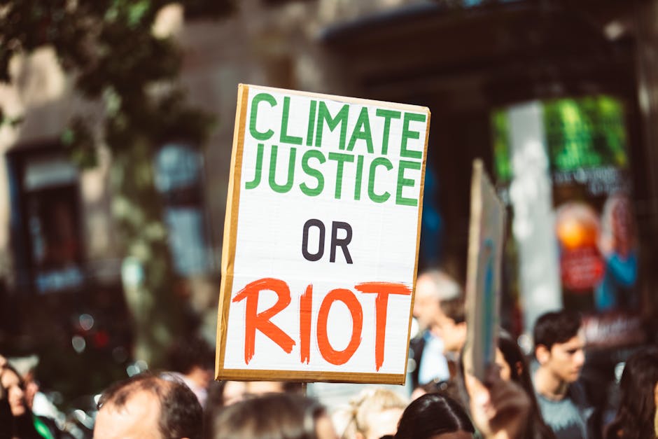 Guerrilla Girls participating in an environmental protest, holding signs about climate change