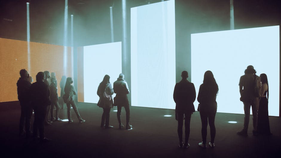 An immersive digital art exhibition with people interacting with large-scale projections and touchscreens