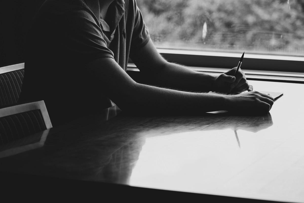 A person engaged in mindful doodling during a work break, with art supplies and a journal nearby, showcasing the integration of artistic activities in daily life