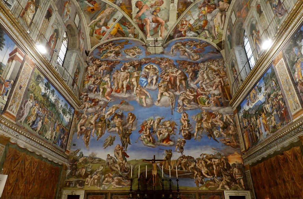 A detailed view of Michelangelo's The Last Judgment fresco, highlighting the use of contrasting colors to depict salvation and damnation