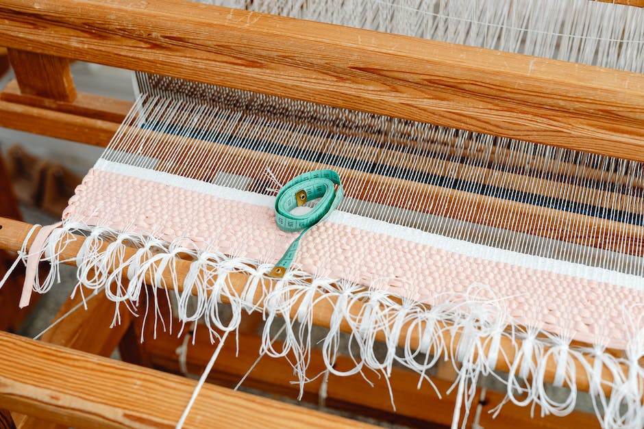 Image of a tapestry weaving together threads with dashes instead of spaces