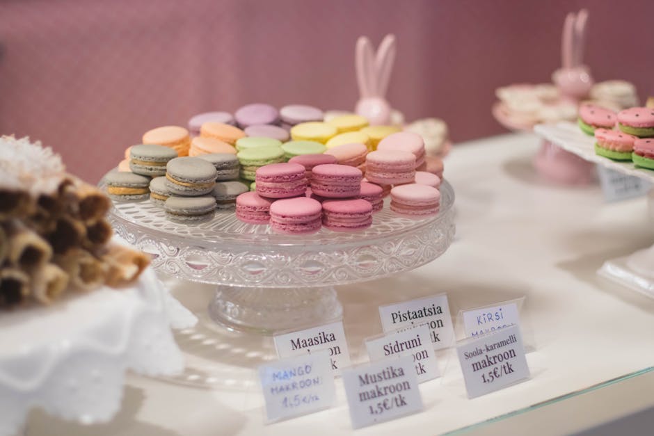 Interior of a New York City bakery with lavender walls, featuring pastel-colored decor and display cases filled with pastries