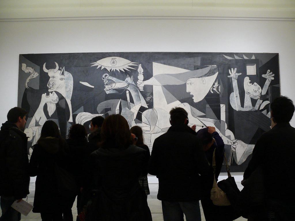 Museum visitors looking at Pablo Picasso's 'Guernica' painting