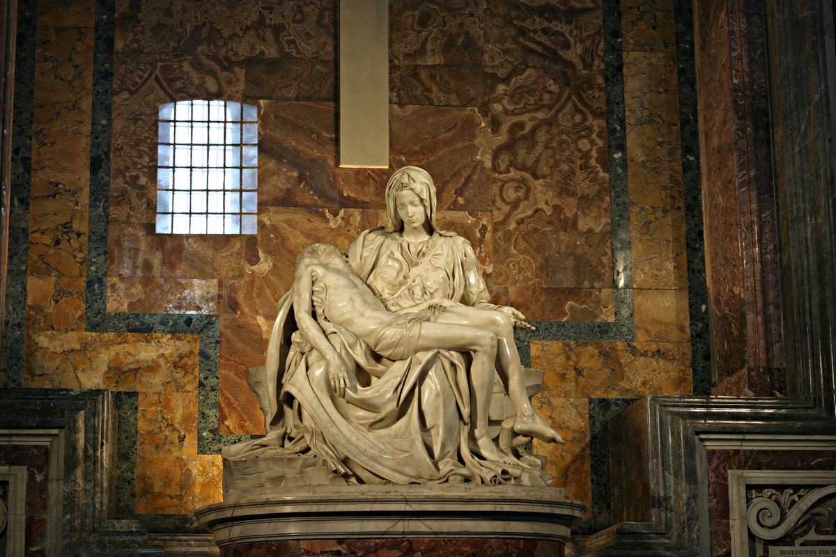 Michelangelo's Pietà sculpture bathed in natural light, emphasizing the interplay of light and shadow on the marble surface