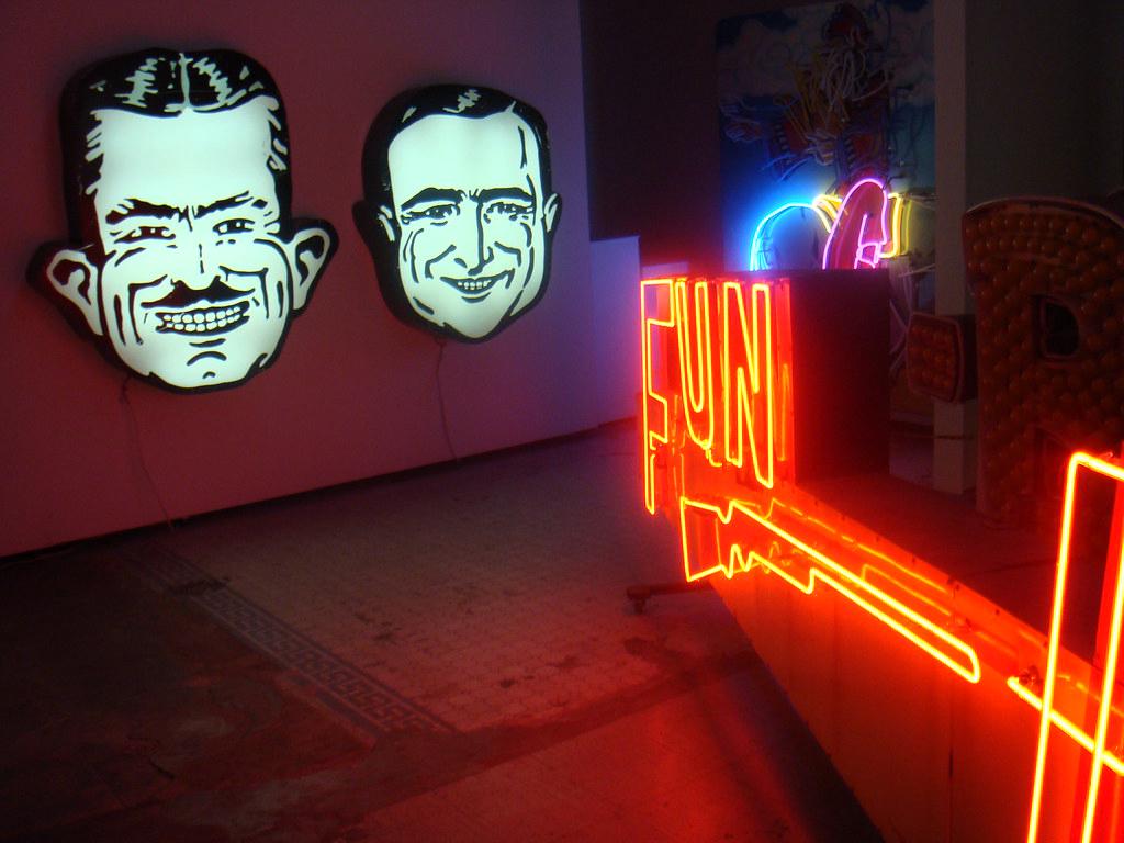 A contemporary art gallery showcasing various postmodern neon artworks