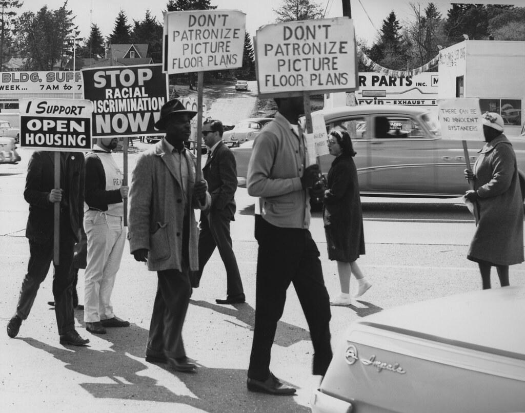 A gallery wall displaying impactful protest photographs from various eras