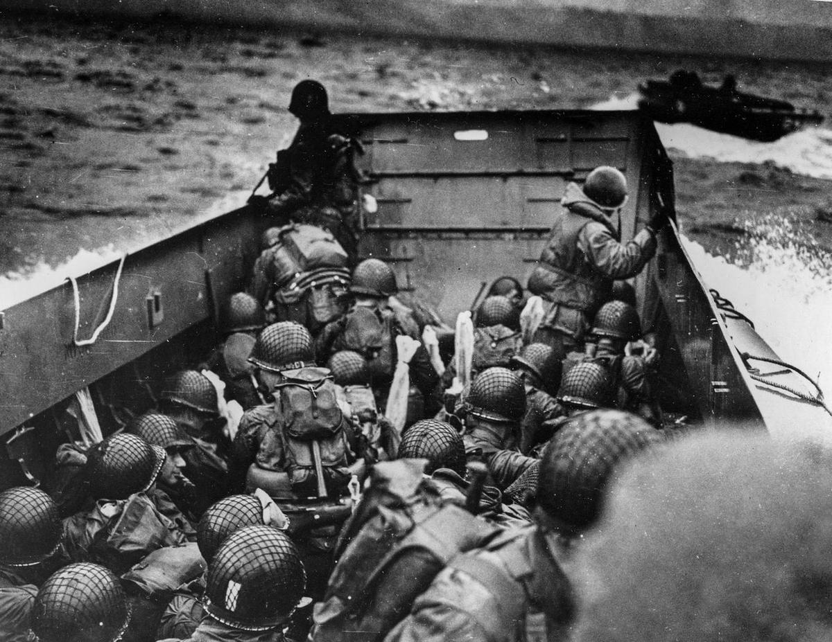 Robert Capa's iconic photograph of American troops landing on Omaha Beach during the D-Day invasion, capturing the chaos and courage of the moment.