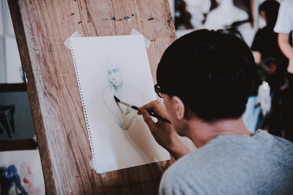 A work-in-progress portrait being drawn using the grid method, with the reference photo and grid visible. The focus is on a single grid square being transferred from the photo to the drawing.